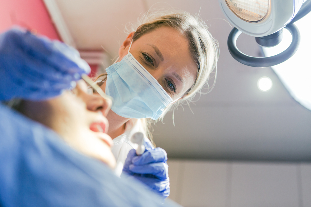 close up photo of a dentist working in a patients mouth