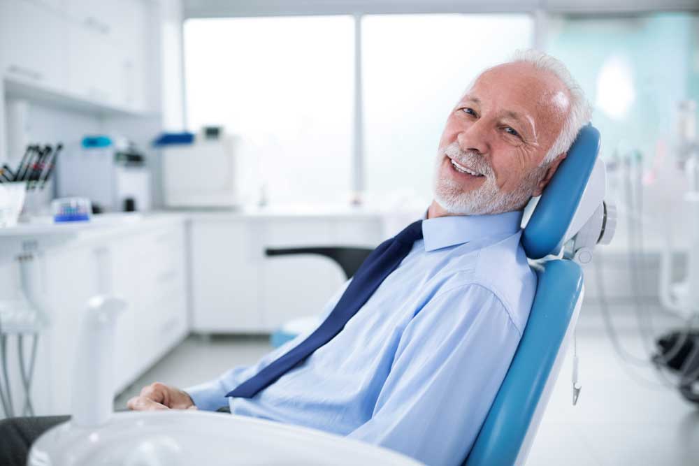 patient smiling after his dental treatment with IV sedation